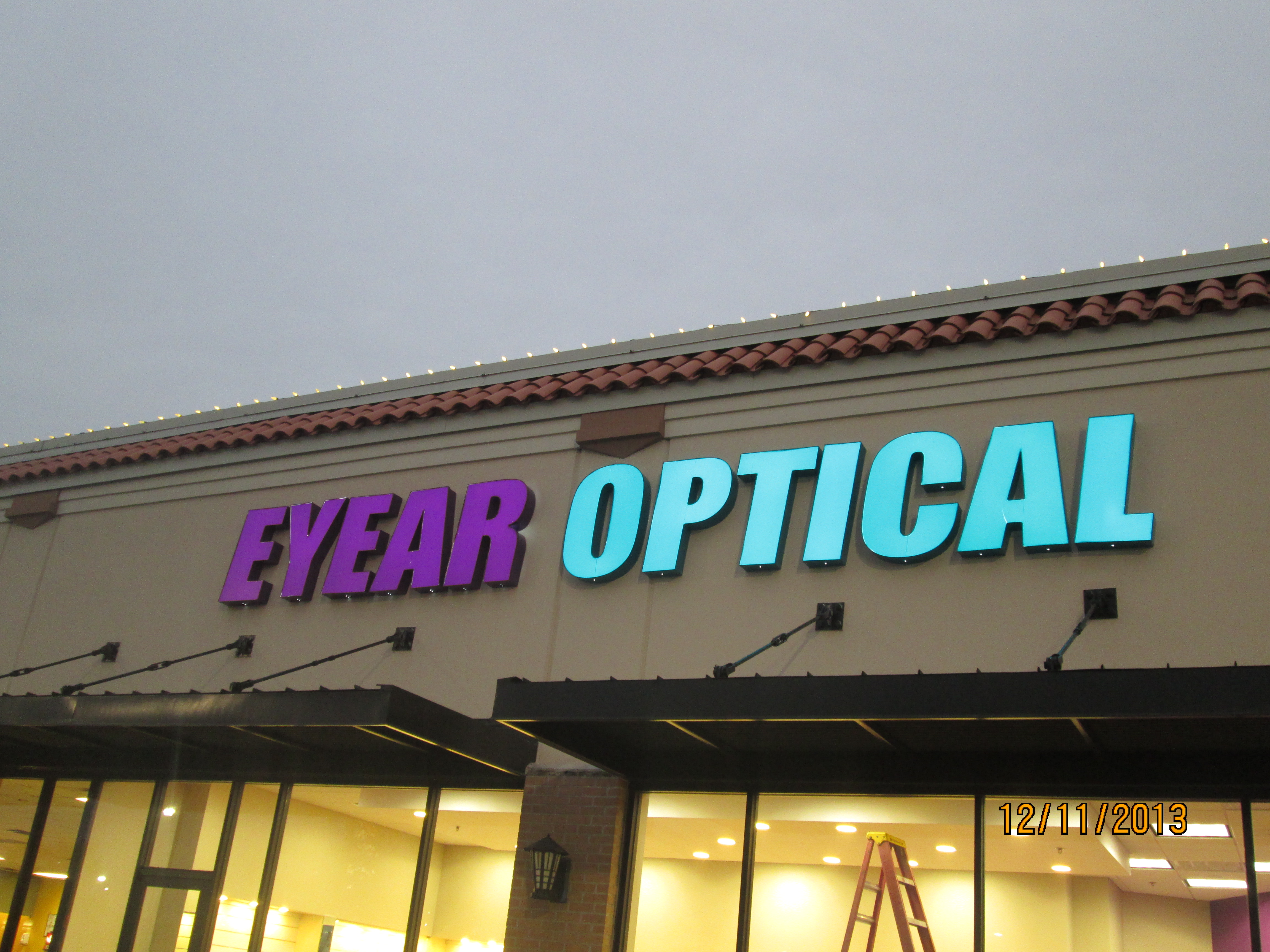 Enhanced Eye Ear Optical's facade with striking illuminated signage for optimal visibility and brand distinction.